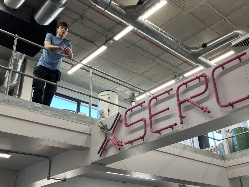 Conor Dowds looks down from the raised walkway in the SERC Lisburn Campus plumbing workshop